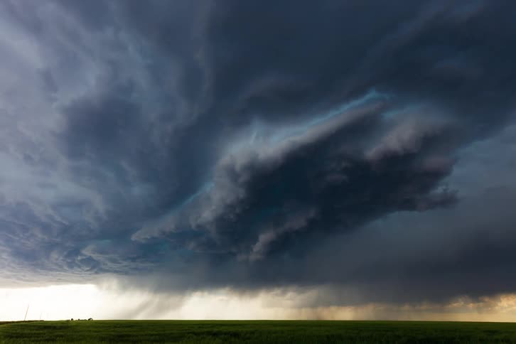 Dark clouds covering the sky over the countryside signaling an approaching storm at midday