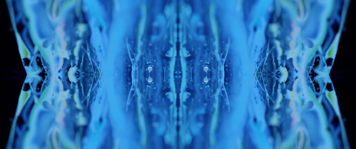 This video showcases a mesmerizing and perfectly symmetrical abstract animation dominated by various shades of vibrant blue the fluid and organic patterns slowly shift and undulate creating a hypnotic kaleidoscopic effect reminiscent of ink spreading