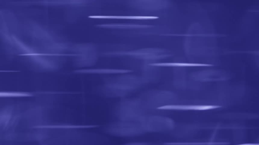 Blurred circular shapes appear in motion against a blue background