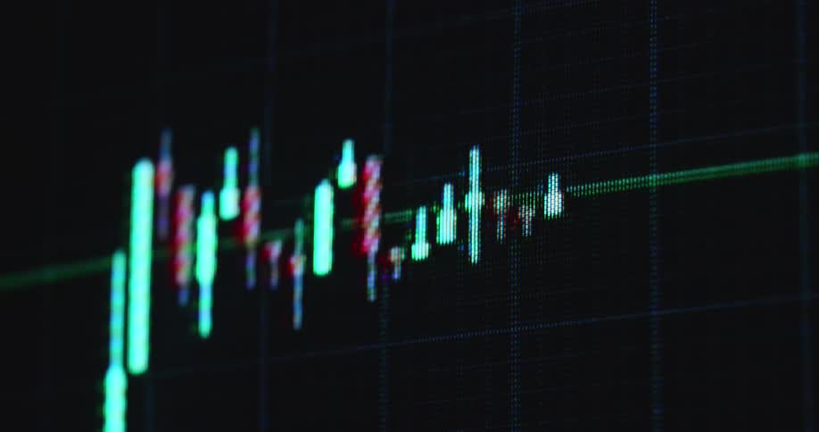 A bullish candlestick chart pattern moves on the computer monitor with visible pixels as the bull flag breaks resistance to the upside causing massive surge and gain for investors and traders trading stocks and crypto currency coins or tokens online