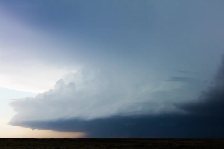 Stormy clouds over a plain area with green vegetation outdoors during day time