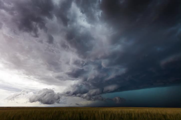 The storm clouds spin and grow