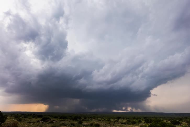 A heavy rainstorm forms in the distance