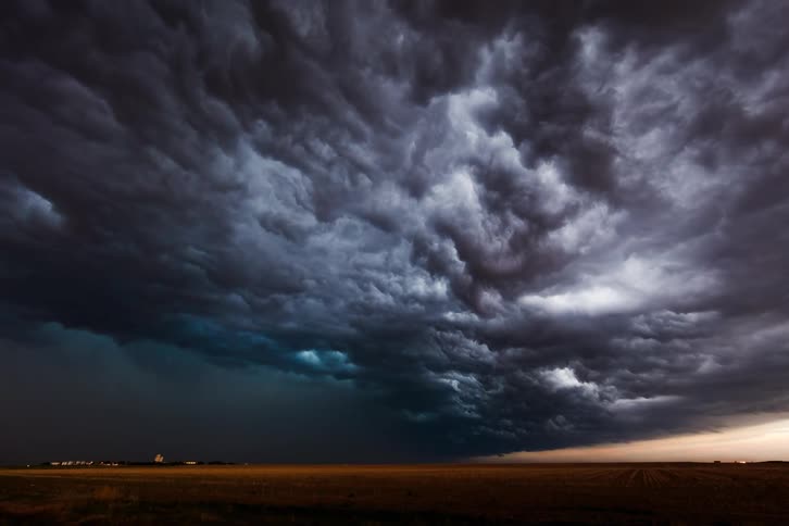 Heavy clouds spin in the sky and pour rain