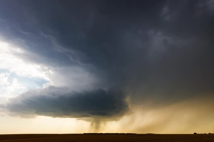 Dark clouds form a storm over the open field