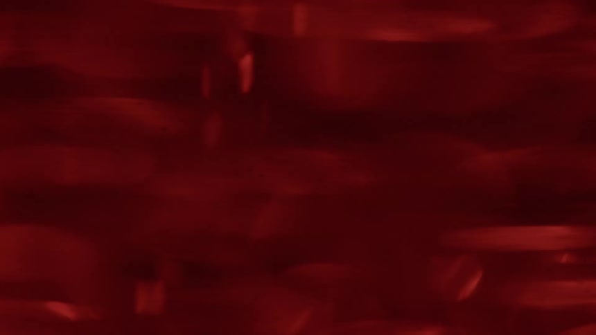 Abstract streaks of red lights blend together in motion