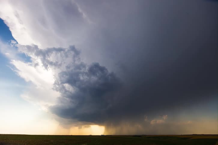 The rain is pouring from the large storm clouds ahead