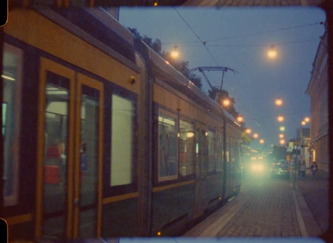 An old tram pulls up to a stop
