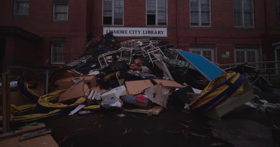 Debris and destroyed furniture are piled up in front of lismore city library