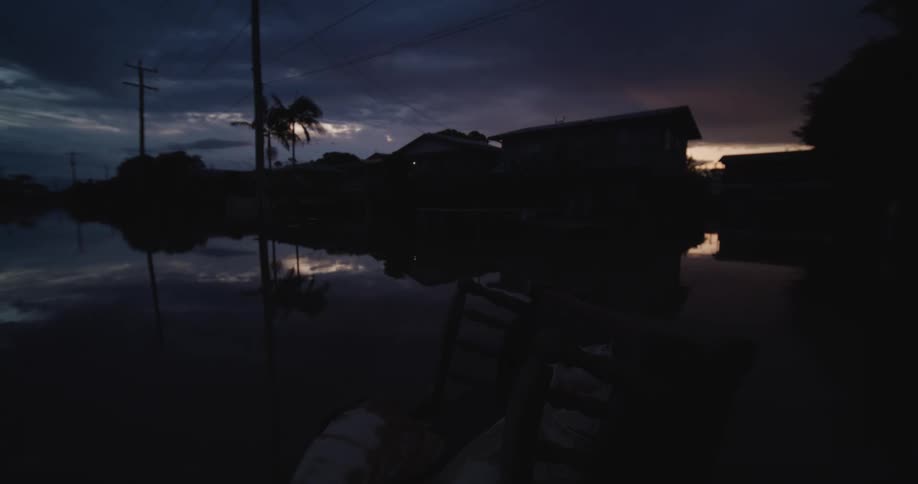 Night falls on a flooded street