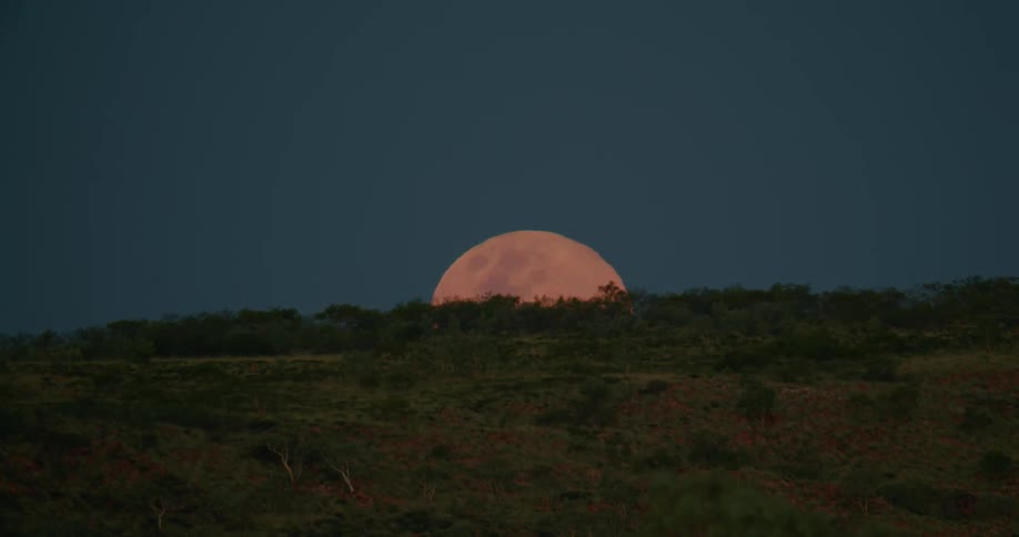 A full moon rising over the land