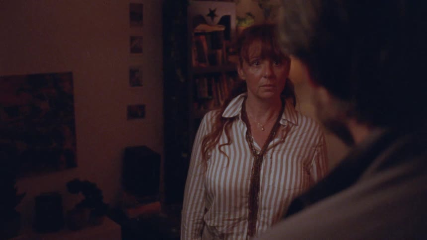 A woman is talking with a man at home