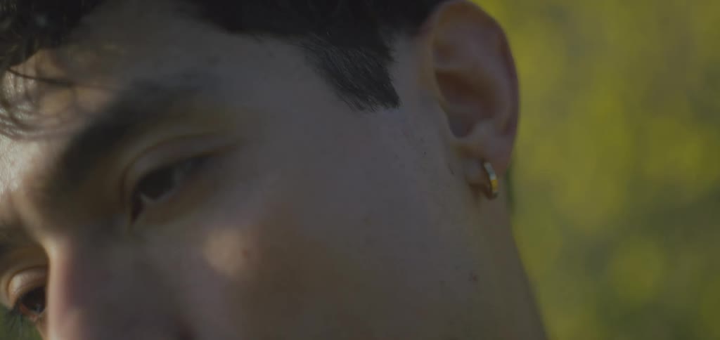 A slowmotion closeup shot focuses on a mans face