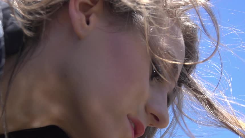 Woman holding her hair on a sunny day