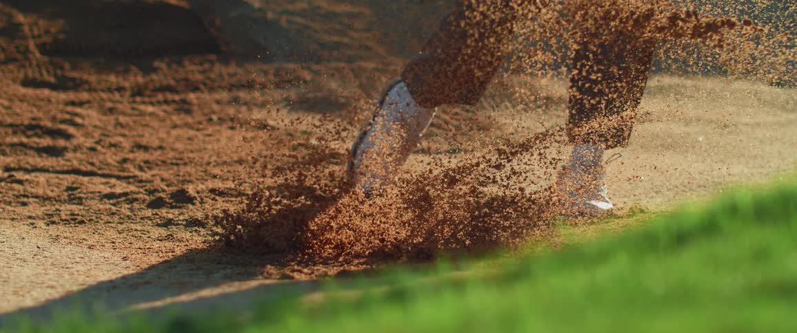 A man strikes a golf ball