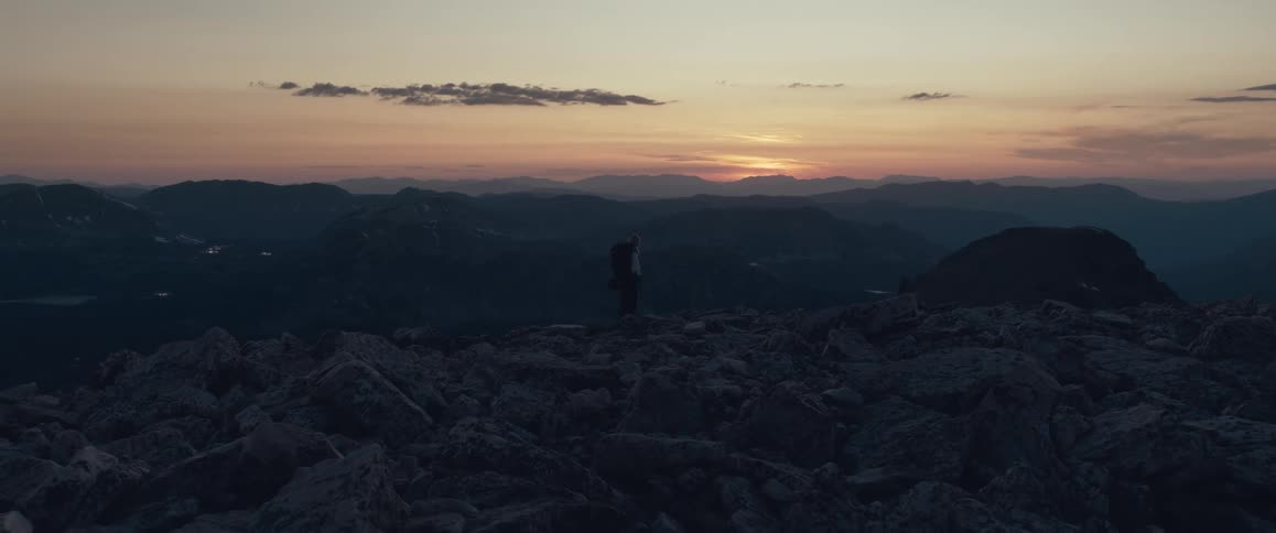 The sun is slowly rising on the landscape full of mountains
