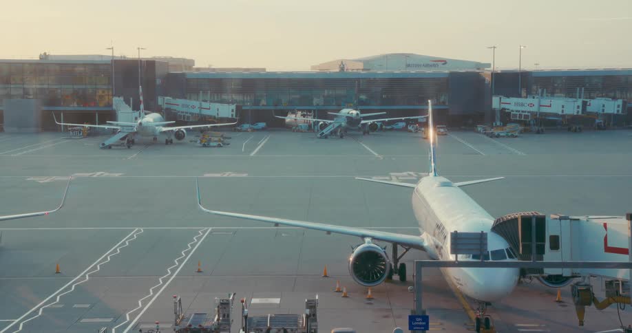 Airplanes parked on the airport apron near the boarding gates