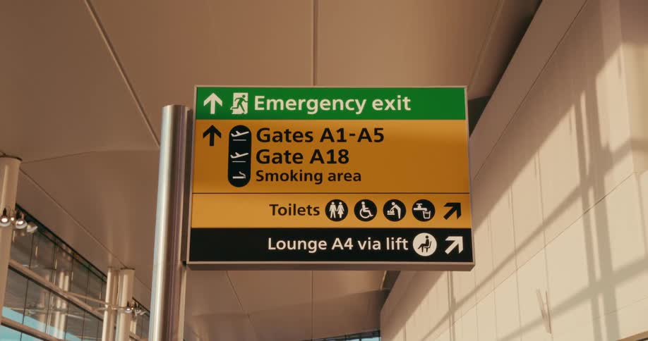 Airport sign shows gates emergency exit toilets and lounge