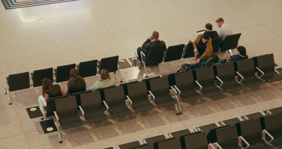 Woman puts something in her bag in a mostly empty waiting area