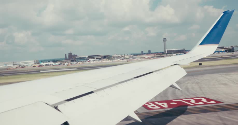 Aircraft taxiing on the runway closes its wing flaps