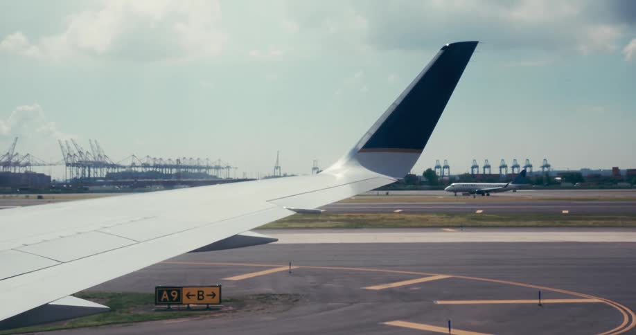 Airplane wing seen from the window while the aircraft was taxiing on the runway