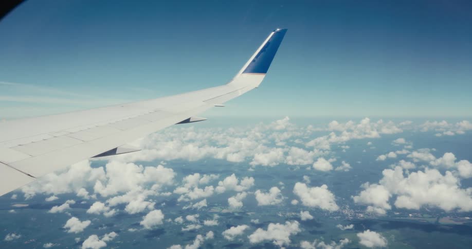 Wing of an airplane flying on the sky outdoors during day time