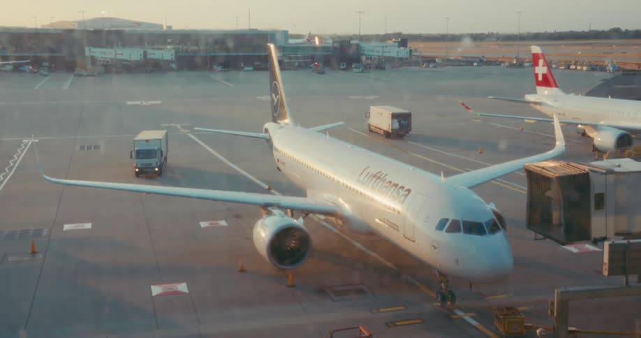 Two planes parked at an airport