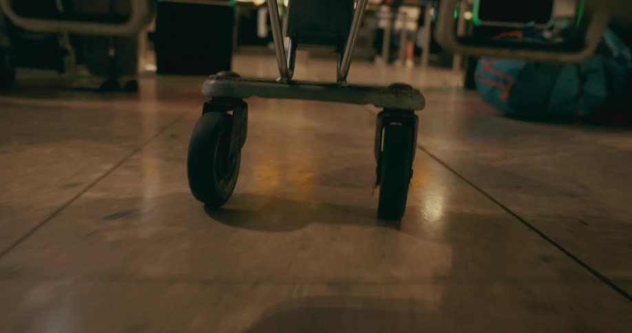 Closeup of cart wheels on an indoor floor
