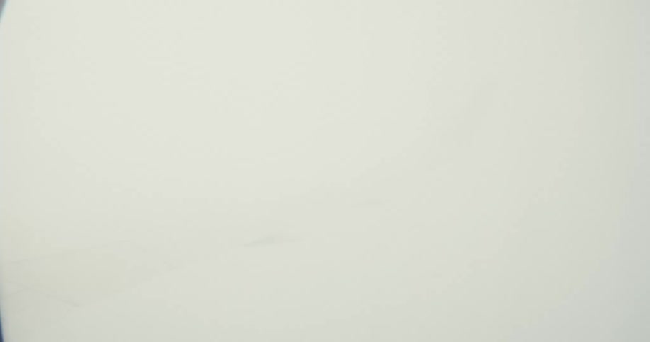 Wing of an airplane flying on the sky among heavy clouds outdoors during day time