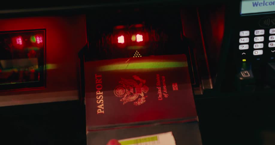 Man scanning a passport on a machine indoors