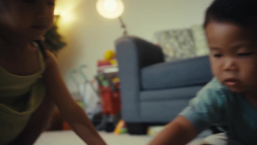 Brother and sister play in the living room
