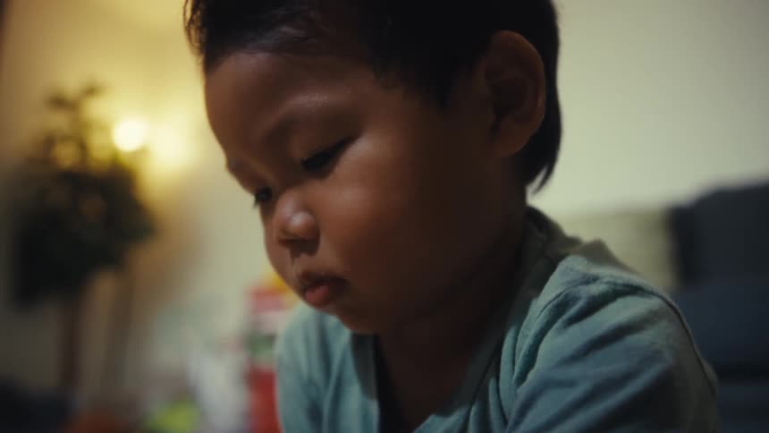 Children assemble pieces of a colorful puzzle on the floor