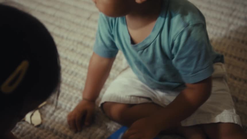 A brother and sister play with a toy map