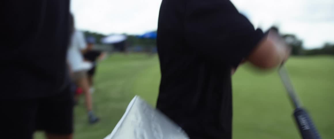 The child pulls a golf club from the bag