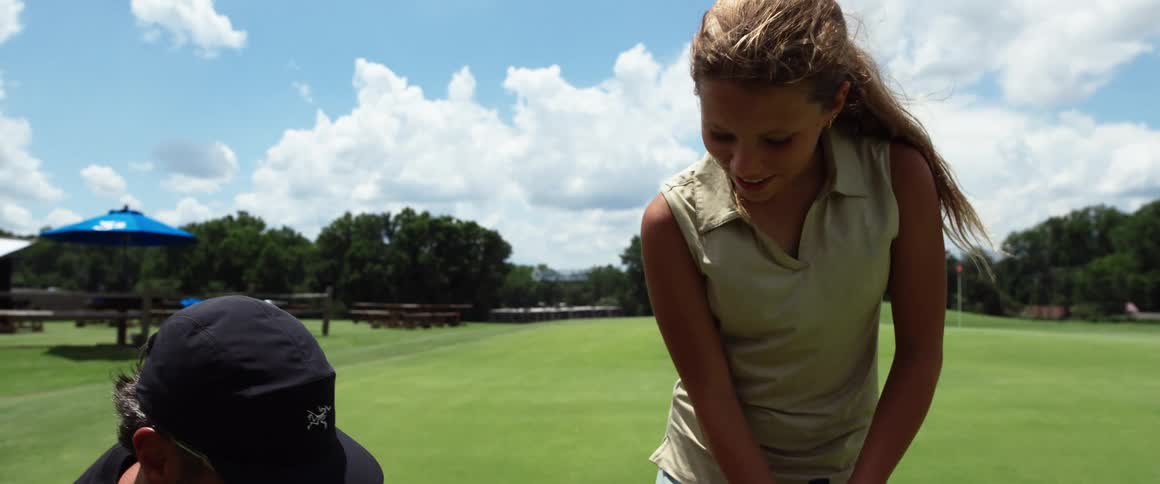 Woman and a man on a golf course during the day