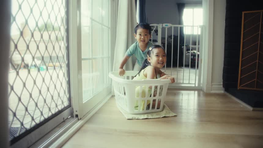 Two small children playing in a room of the house