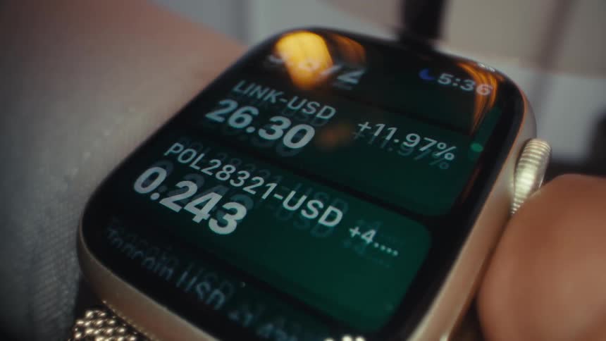 A person scrolls stock numbers on their smart watch