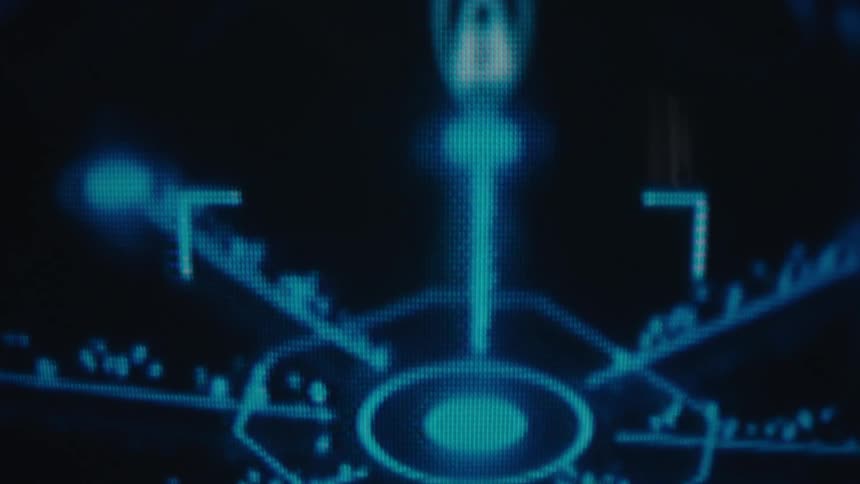 A digital display shows a bright blue abstract graphic of connected dots and lines that moves and dissolves into a vertical pattern of colored dots against a black background