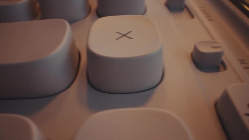 A persons finger presses a button with a plus sign on a calculator