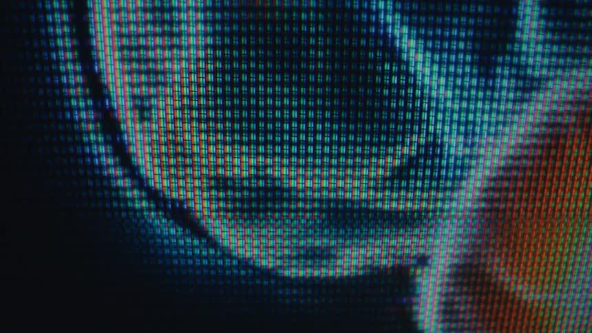 The monitor shows a persons brain glowing