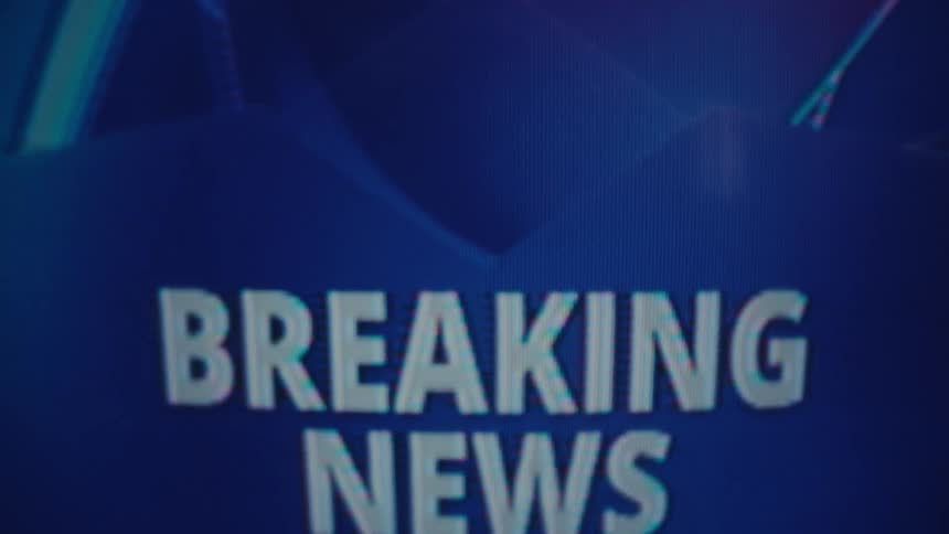 The news is playing on the television