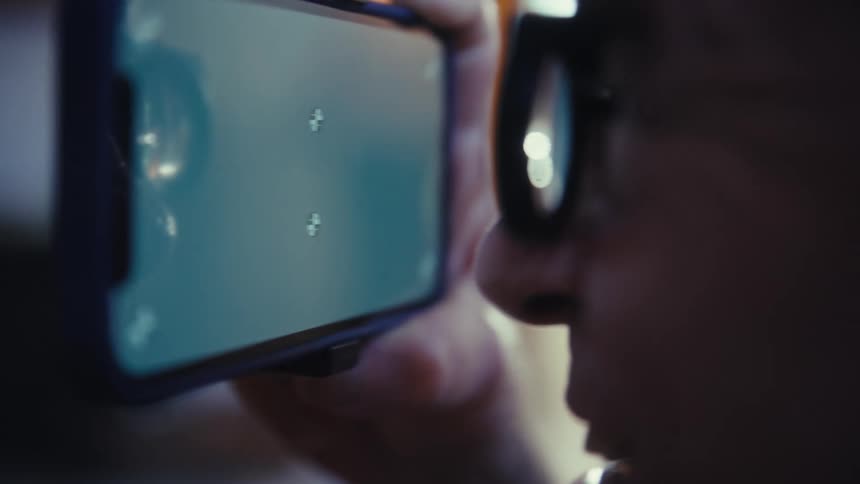 Person closely observes a screen displaying crosshair symbols