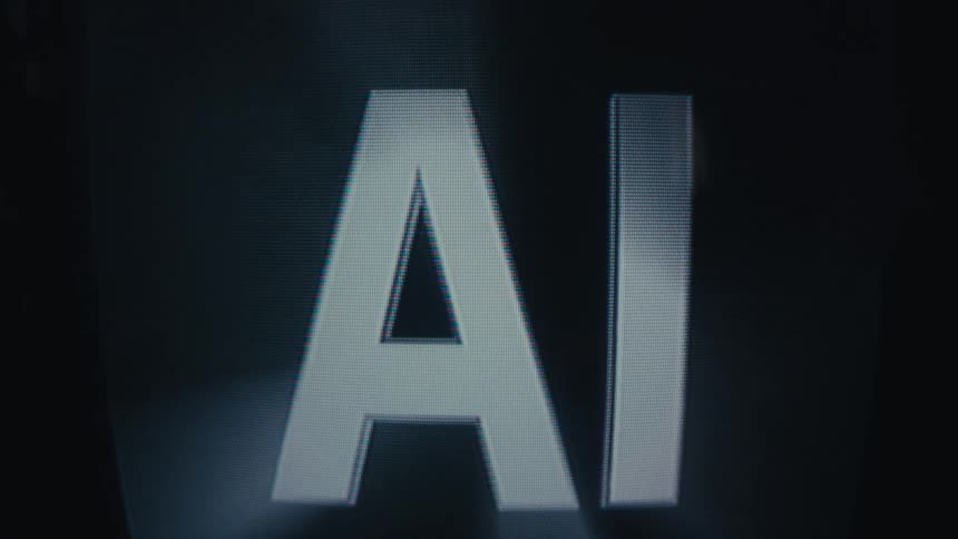 The letters ai appear on a dark screen with a pixelated digital texture illuminated by a flickering light before fading back into blackness