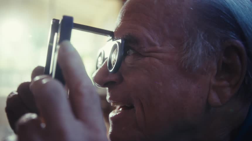 A man happily looks at his phone