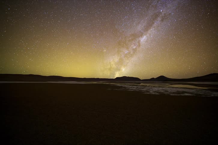 Starry sky reveals the milky way over a dark landscape