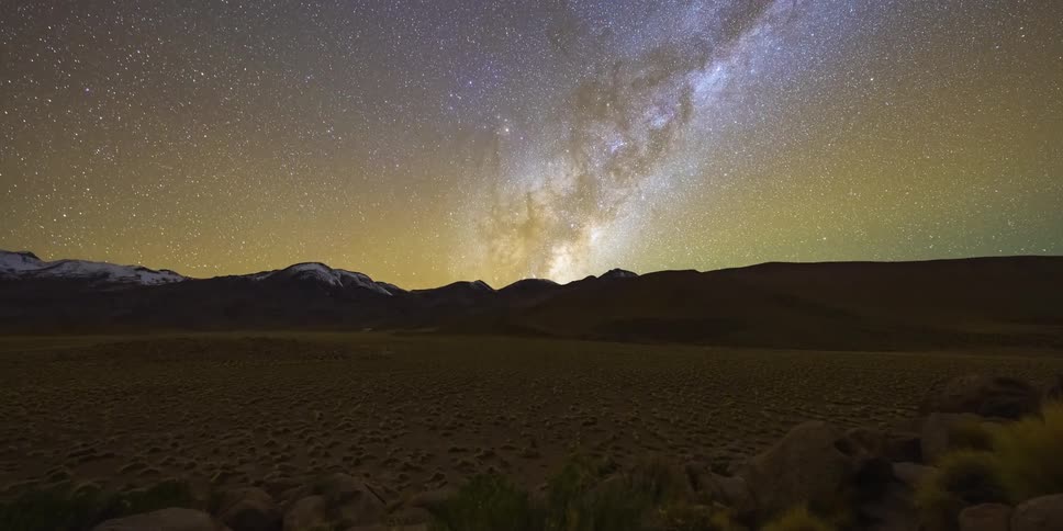 Starry sky with the milky way above dark mountains