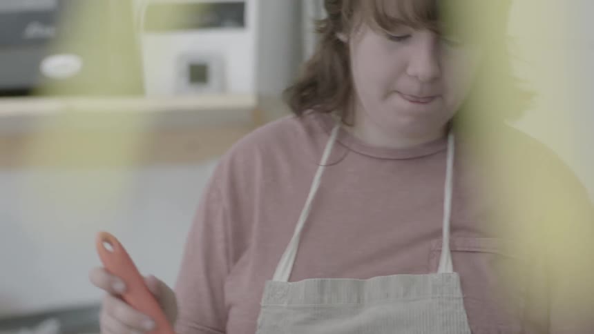 A woman is stirring a pot on a stove