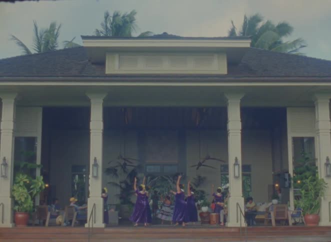 A group are dancing together on the villa porch