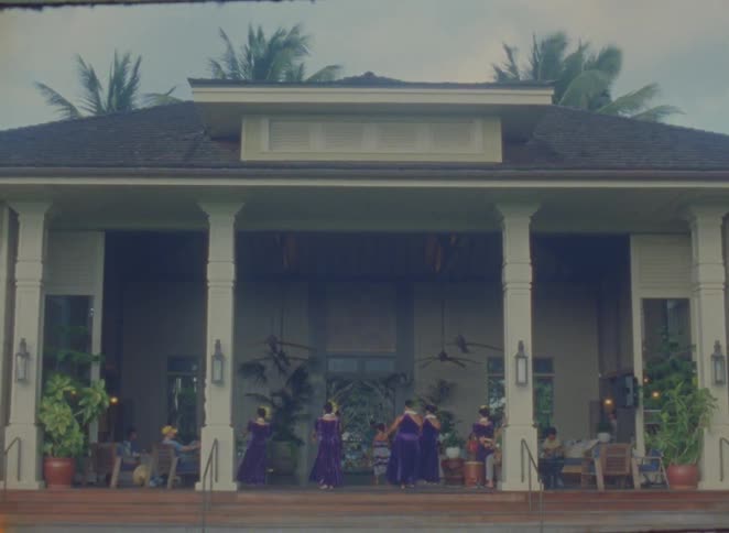 Group of people performing a dance performance in a house outdoor area
