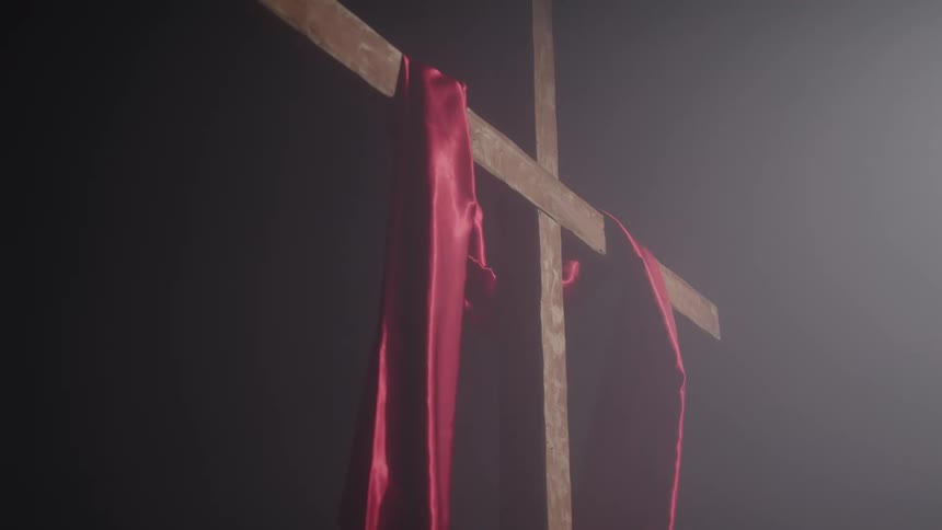 Wooden cross with a red scarf